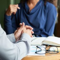 Close-up image of business people having meeting in cafe